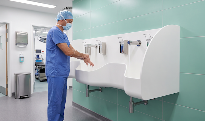 Surgeon washing hands at a WDO surgical scrub sink, made from Corian solid surface